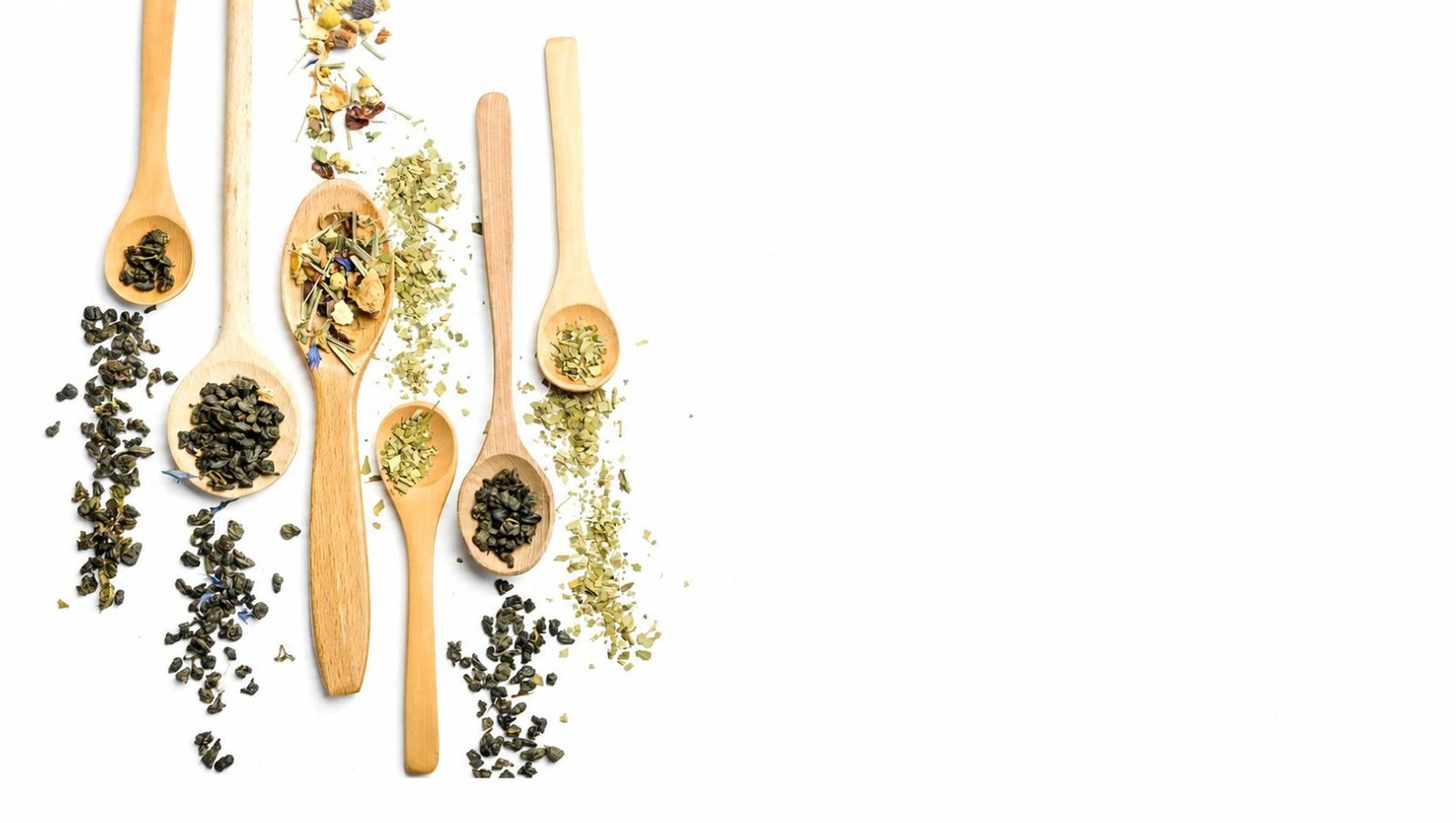 Assorted dried herbs and spice blends on wooden spoons
